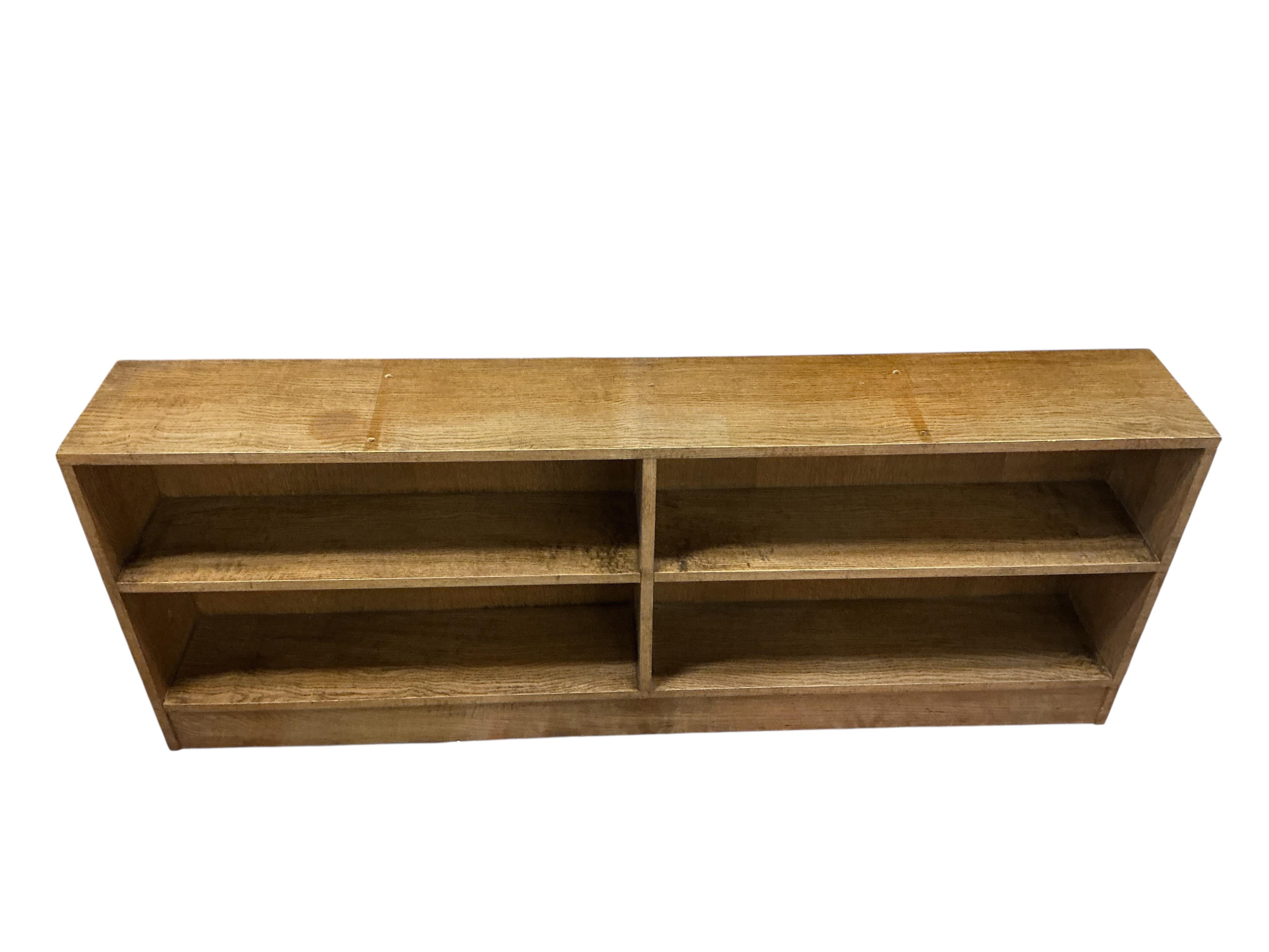A mid century oak dwarf open bookcase, width 176cm, depth 27cm, height 67cm